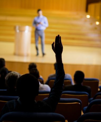 Male business executive giving a speech at conference center